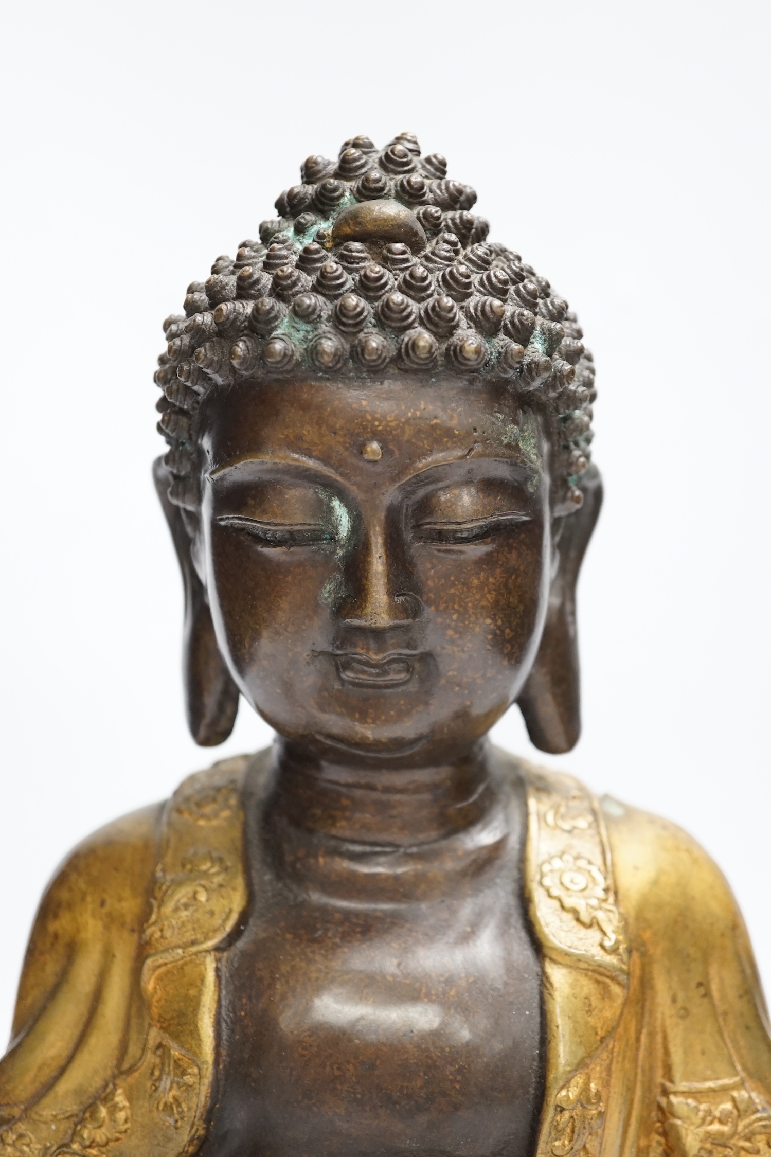 A gilt bronze seated Buddha, 35cm high